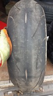Bald worn out motorcycle tyre replaced by Mototyres 2 u mobile motorbike tyre fitting